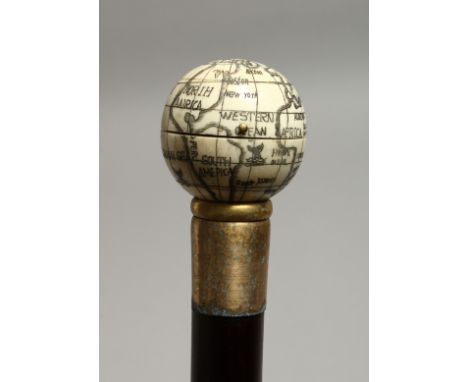 A WALKING STICK WITH A GLOBE COMPASS