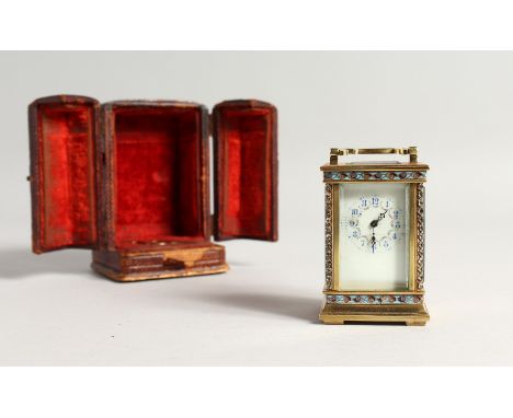 A SUPERB 19TH CENTURY FRENCH BRASS AND ENAMEL CARRIAGE CLOCK, the sides with brilliants, the face with blue numbers and garla