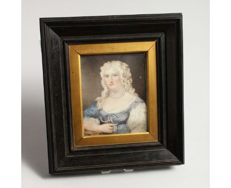 A 19TH CENTURY PORTRAIT MINIATURE OF A LADY with long curly hair 3.75in x 3ins in a gilt and wooden frame.