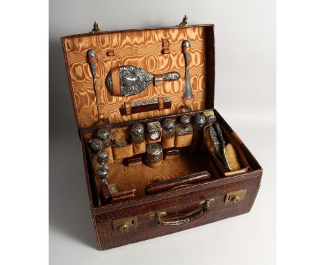 A VERY FINE VICTORIAN CROCODILE AND SILVER TRAVELLING CASE, filled with clock, nine silver top bottles, hand mirror, button h