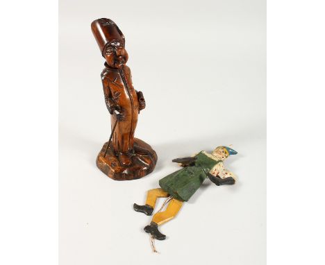 A CARVED TREEN FIGURAL PIPE and stand, 8.5ins high, and a puppet (2)