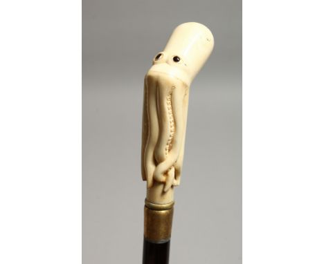 A WALKING STICK WITH A CARVED BONE OCTOPUS HANDLE 34ins long