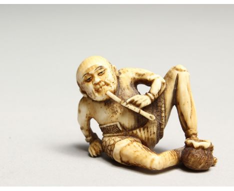 A CARVED BONE NETSUKE OF AN ONI 1.5ins.
