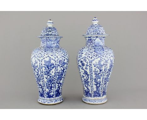 A pair of Chinese porcelain blue and white vases and covers, Kangxi, ca. 1700 H: 54 cm With a small repair on the top rim of 