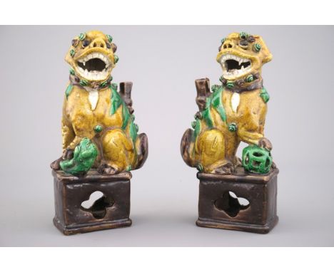 A pair of Chinese sancai glazed pottery Buddhist lion joss-stick holders, 18th C. H: 17 cm