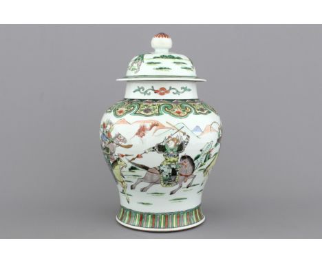 A Chinese porcelain wucai vase and cover depicting warriors on horseback, 19th C. H: 39 cm. A chip to the finial and a small 