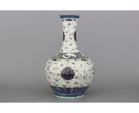 A Chinese porcelain doucai and gilt bottle vase, 19th C. Marked with a 4-character Kangxi mark. Condition: Perfect. H: 39 cm