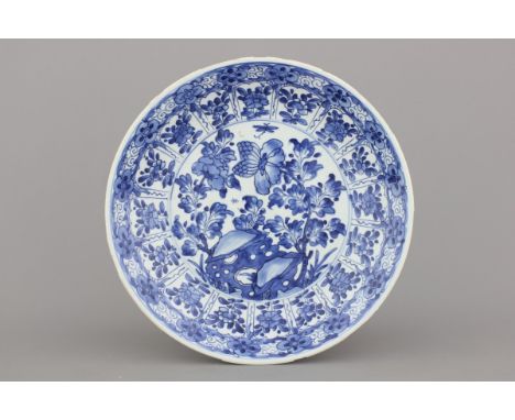 A Chinese porcelain blue and white dish, Kangxi, early 18th C. Dia: 35,5 cm. Some wear to the edges. 