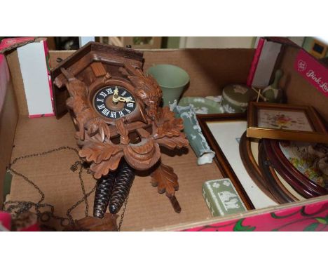 A box containing a carved wooden cuckoo clock, Wedgwood green jasperwares, etc