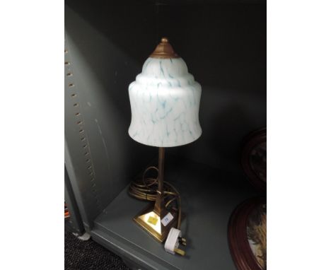 A solid bodied desktop lamp with mottled blue light shade