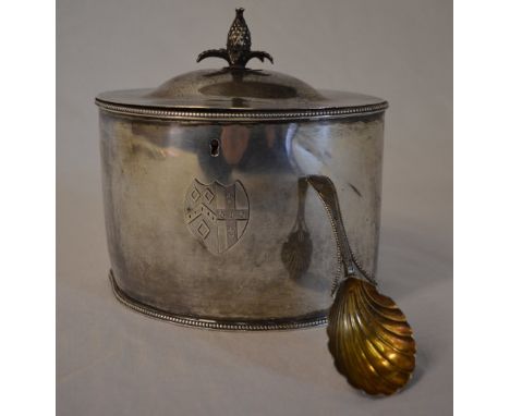 George III silver tea caddy engraved with heraldic shield crest and rams head, pineapple finial London 1788 and a Georgian si
