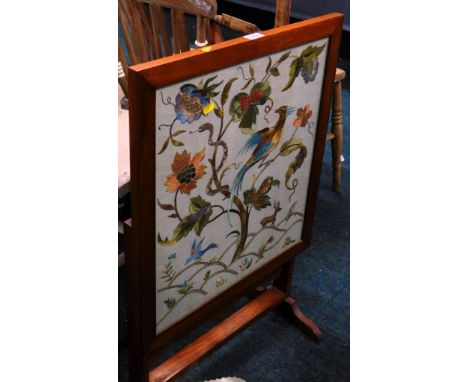 A tapestry fire screen, depicting bird of paradise, stag and snake on perch of flowers.