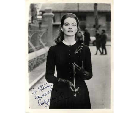 CAPUCINE: (1928-1990) French Actress &amp; Model. Vintage signed and inscribed 8 x 10 photograph of the actress standing outd