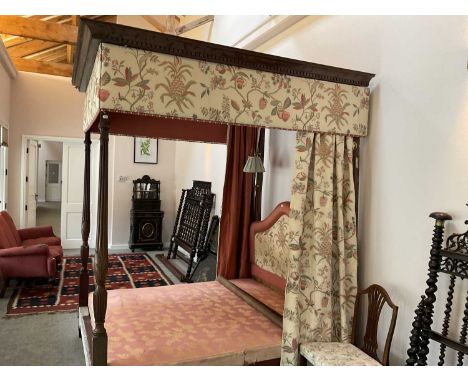 A George III-Style Carved Mahogany Four-Poster Bed, 19th century in part, with later cream crewel-style pelmet and curtains b