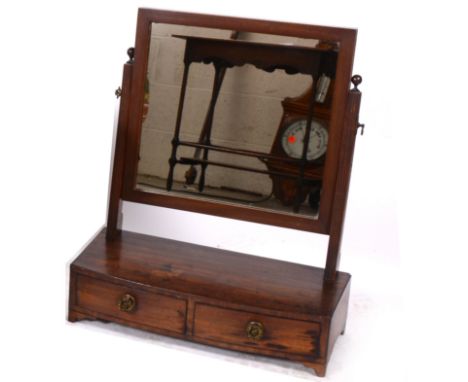 A 19th century mahogany toilet mirror, rectangular plate on reeded supports, above bowfron base section with two drawers, rai