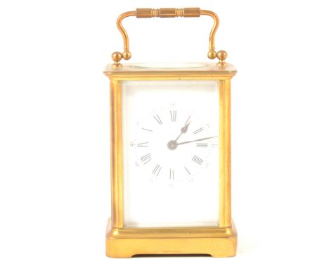 A French brass carriage clock, white enamel dial with both Arabic and Roman numeral chapter rings, stamped Brevete H.A. to ba