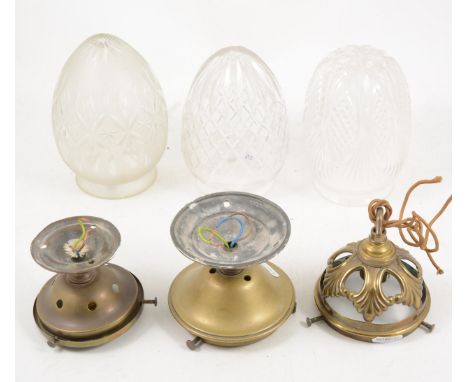 An Edwardian pendant light, pierce brass fitting, cut-glass shade, 24cm; and two other similar pendant light fittings,(3).