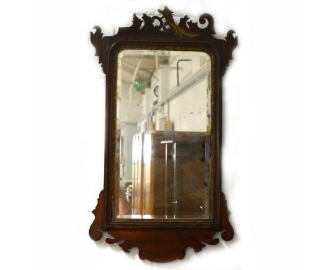 A Chippendale style wall mirror, walnut frame with shaped outline and carved bird to cresting (mostly lost), arched rectangul