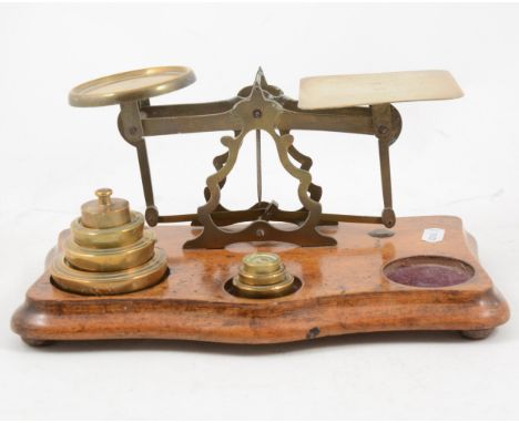 Set of mahogany and brass postal scales, with some weights, 27cm.