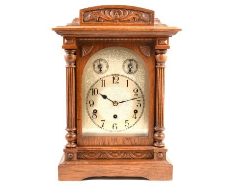 Edwardian oak mantel clock, dome top case, carved columns to the front, rectangular silvered dial, continental movement strik