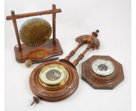 An oak table gong, with mallet, 26cm; an oak cased octagonal wall mounted aneroid barometer; and a walnut cased wall mounted 