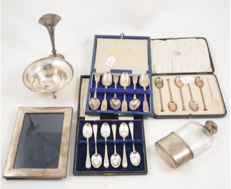 Three sets of cased silver teaspoons, set of six fiddle pattern, feather edge and five nail top spoons, a glass hip flask wit