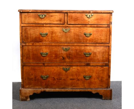 A George III walnut chest of drawers, rectangular top with rounded corners, moulded edge, boxwood stringing, broad cross-band
