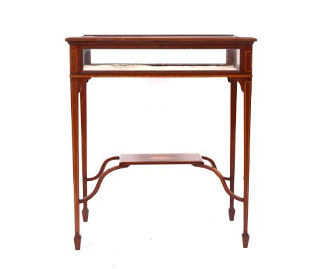 An Edwardian glass-top display table, crossbanded and boxstrung outlines, square tapering supports joined by cross stretchers