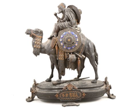 Late 19th Century mantel clock, designed with a figure riding a Camel, carrying a shield with enamelled numerals, oval plinth