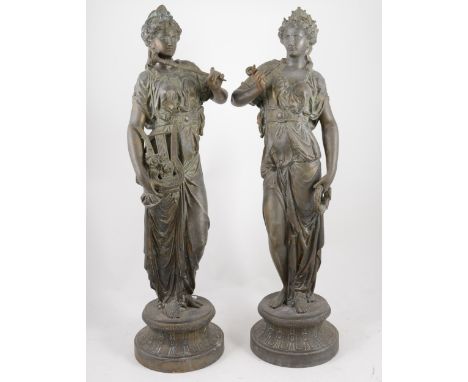 Pair of spelter patinated figures of muses, standing in diaphanous robes, holding a lyre, pipe and letter, circular pedestal 