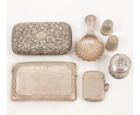 A Georgian silver caddy spoon, marks worn, shell bowl, a Continental silver pill box, silver case case, silver vesta, two sil