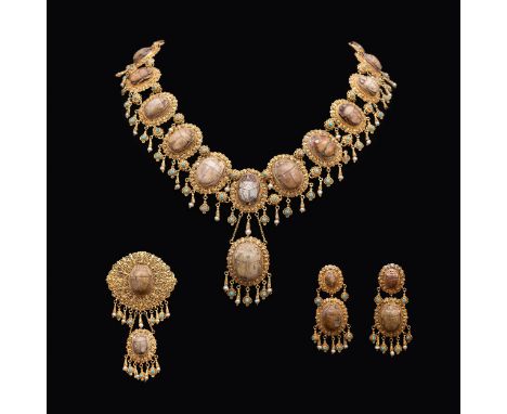 An unusual mid 19 th Century Egyptian Revival yellow metal mounted ceramic scarab necklace, the eighteen graduated insects in
