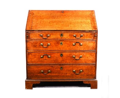 A Georgian oak bureau, the crossbanded slope enclosing fitted interior of six drawers, eight pigeon holes flanking two pilast