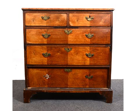 A Georgian walnut chest of drawers, the top with boxwood stringing, broad cross-banding, moulded edge, two short and three lo