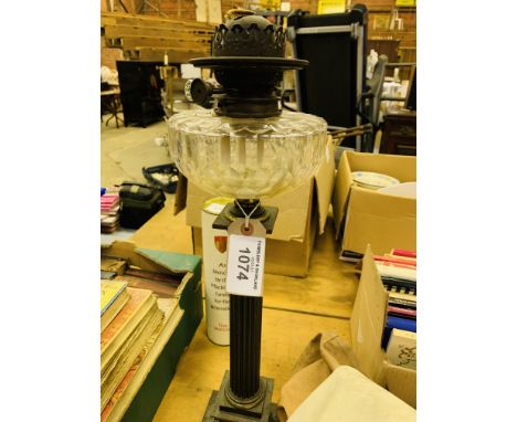 Victorian brass columned oil lamp by Jones and Willis. Estimate £10-20.