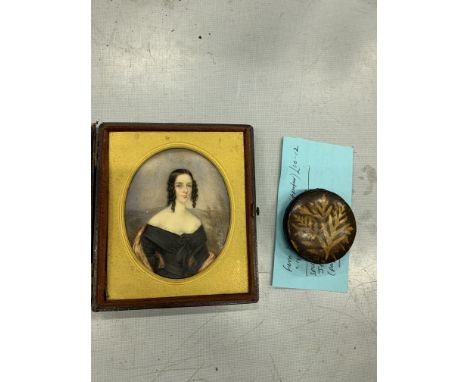 Oil on ivorine miniature of a Victorian lady, in a leather case, case badly damaged; together with a Victorian fern pin cushi