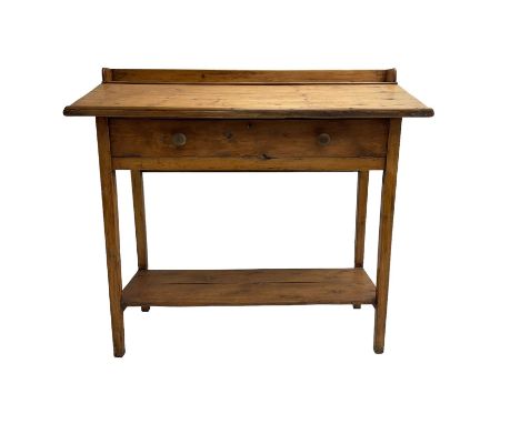 Stained pine clerks desk or table, raised back and sloped writing surface over single fall-front cupboard, raised on square s