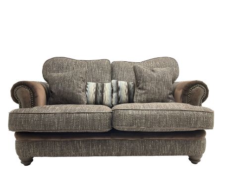 'Canterbury' two seat sofa upholstered in brown fabric with contrasting textures, traditional shape with scrolled arms and st