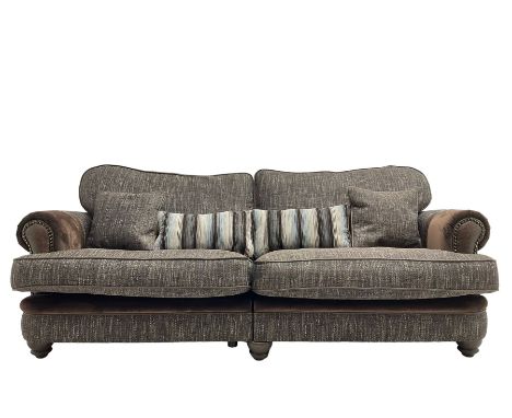 'Canterbury' Grande four seat sofa upholstered in brown fabric with contrasting textures, traditional shape with scrolled arm