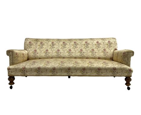 Victorian three seat sofa, upholstered in floral and scrolling foliate patterned fabric with sprung seat, raised on turned su