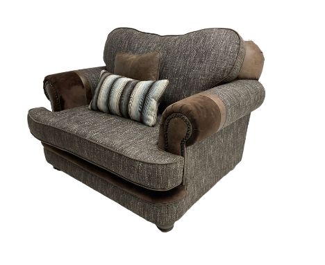 'Canterbury' snuggler sofa upholstered in brown fabric with contrasting textures, traditional shape with scrolled arms and st