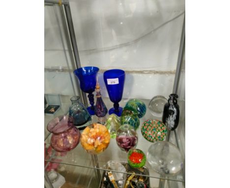 Shelf of art glass wares includes blue Bristol glasses etc. 