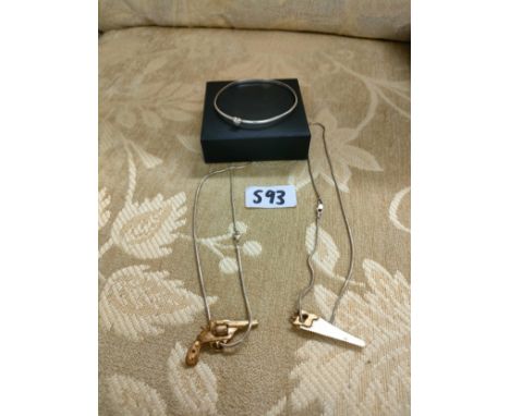 2 silver necklaces with gun and saw pendants together with silver bangle. 