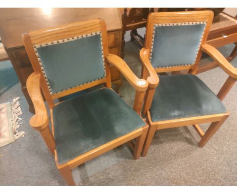 Pair of oak light wood arm chairs with blue upholstery. 