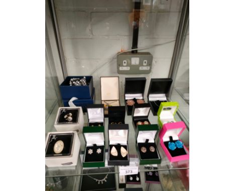 Shelf of costume jewellery boxed . 