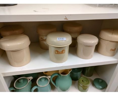 Shelf of antique ceramic storage jars . 