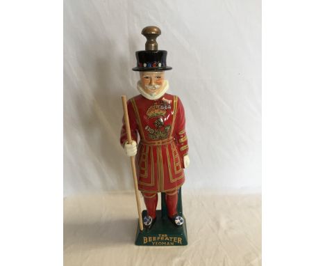 A Carlton ware advertising figure for The Beefeater Yeoman Gin, the beefeater depicted holding a wooden staff.  16ins.  