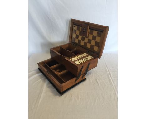 An Edwardian cantilevered games compendium, the marquetry inlaid lid depicting chess pieces and with a chequer board decorate