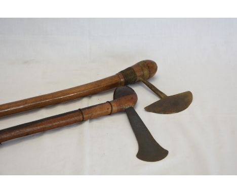 An African axe with demi lune shaped blade and bulbous terminal to the wire wrapped handle.  29ins together with an African a