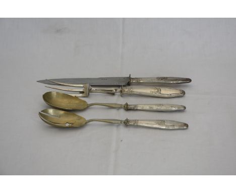 A French silver plated handled carving set comprising carving knife with blade stamped Paris, carving fork and two serving sp